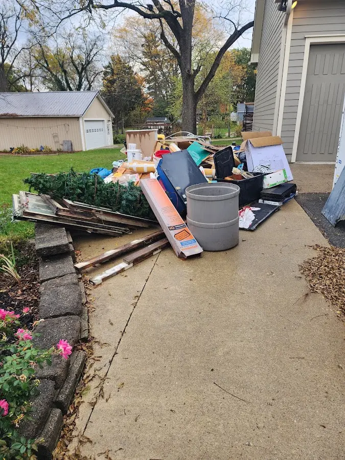 Dumpster being loaded with debris for Commercial Dumpster Rental in Holly Springs